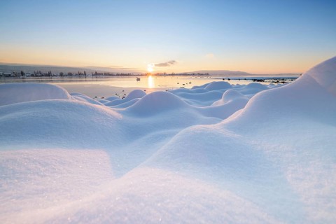 Winter snowy landscape with a lake at sunrise and some clouds, Seegarten, Allensbach, Lake