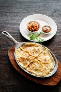 Mexican cheese tortilla quesadilla with salsa and chilli sauce