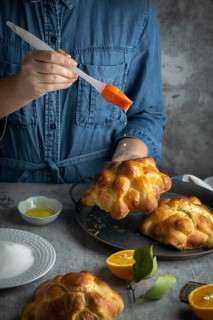 Food Photography, Woman preparing Pan de muertos bread of the dead for Mexican day of the dead