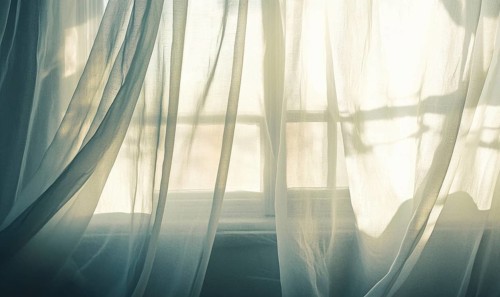 Soft, semi-transparent curtains, lightly billowing in the morning sun AI generated