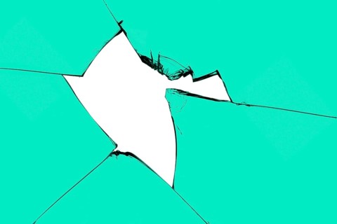 Broken pieces glass mirror isolateda piece of broken glass with a hole and cracks. Green window