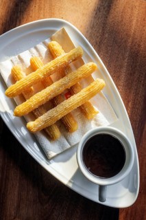 Churros and chocolate spanish donuts pastry doughnuts with sauce breakfast snack