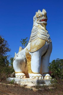 Ancient statue of lion guardian in Shwe Inn Thein Paya temple complex near Inle Lake in central