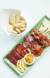 Spanish serrano ham chorizo sausage and cheese tapas snack platter