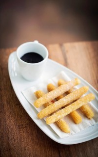 Churros and chocolate spanish donuts pastry doughnuts with sauce breakfast snack