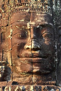 Giant stone face at Bayon Temple at sunset, Angkor Wat, Cambodia, Asia