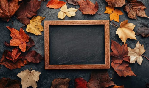 An empty chalkboard with a wooden frame, surrounded by fall-colored autumn leaves AI generated
