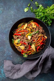 Japanese dish buckwheat soba noodles with chicken and vegetables carrot, bell pepper and green