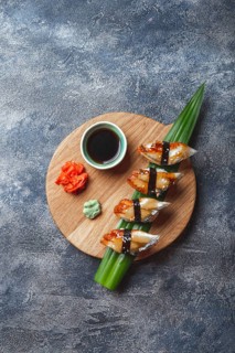 Sashimi sushi set on wooden board. Stone background. Top view