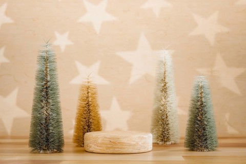 Wooden podium pedestal product mockup display with miniature Christmas trees in beige and green, 3d