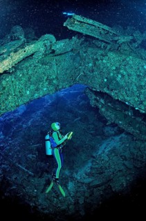 Diver and vehicle wreck in the Blue Belt shipwreck, Sudan, Africa, Red Sea, Sha'ab Su'adi, Africa