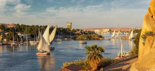 Beautiful panorama landscape with felucca boats on Nile river in Aswan at sunset, Egypt, Africa