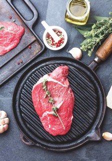 Food, Fresh raw meat. Beef Tenderloin and marbled beef steaks on grill pan and frying board with