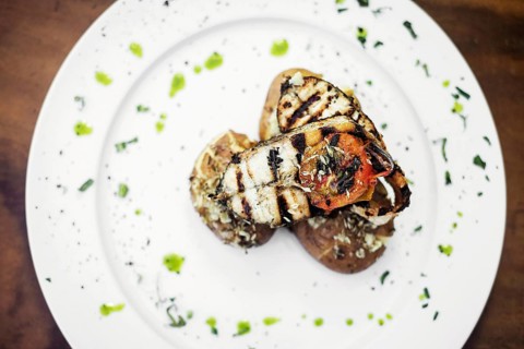 Grilled gourmet bbq fresh fish with roast potatos herbs olive oil garlic sauce
