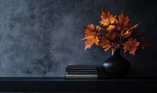 Sleek black table with a couple of books and a vase filled with autumn foliage AI generated