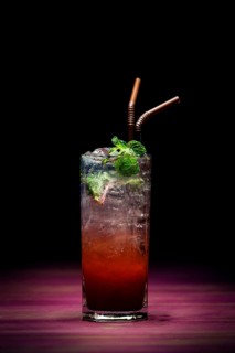 Trendy modern strawberry mojito fusion cocktail in sophisticated lounge bar at night