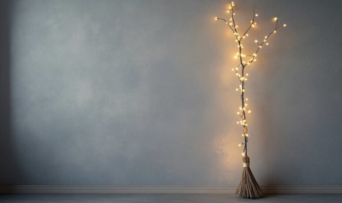 Witch's broom adorned with glowing garlands AI generated