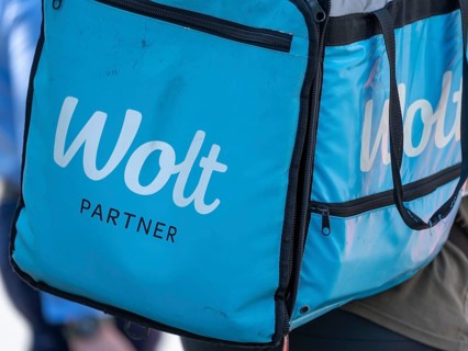 Bicycle courier with light blue bag from Wolt delivery service, Frankfurt am Main, Hesse, Germany,