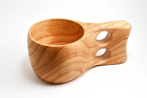 Traditional finnish wooden kuksa cup on white background, wood cup traditional used by the Saami