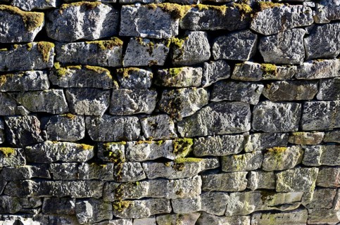 Ancient granite stone wall channel mossy, horizontal