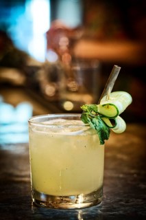 Cucumber lemon mint vodka cocktail drink in modern bar