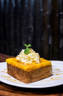 Gourmet fusion french toast with mango and whipped cream