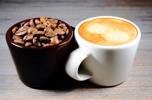 Espresso and cup of coffee beans on wood