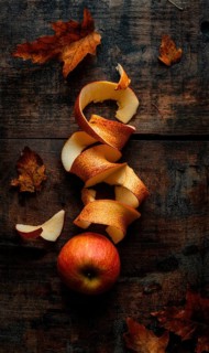 Apple peels on wooden table AI generated