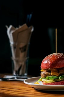 Modern gourmet trendy chicken burger in beetroot bun