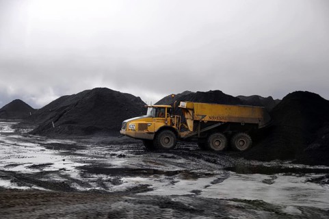 Westport, New Zealand, circa 2009: Coal truck dumps 70 ton load in stockpile at Stockton Coal Mine,