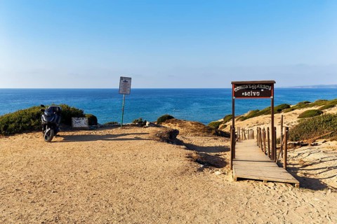 Motorbike on car park with beach access, boardwalk through dune landscape by the sea, Spiaggia di