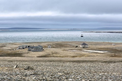 Wooden shacks and cabins at deserted 1950s Kinnvika Arctic research station, Murchisonfjord,