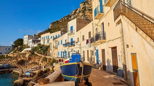 Morning light, row of houses, colourful houses, boat, Levanzo town, main town, Levanzo, Egadi
