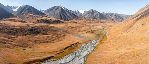 Aerial view, Burkhan mountain valley with meandering river, barren dramatic mountain landscape,