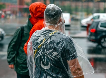 Tourists with rain capes and umbrellas during heavy rainfall, 23.06.2023