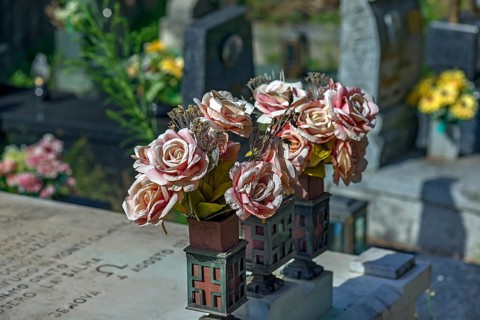 Faded plastic roses on a grave in the Staglieno Monumental Cemetery, Cimitero Monumentale di