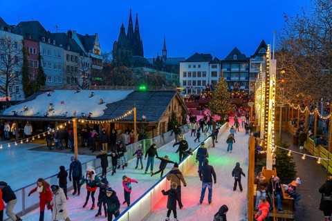 Ice rink at the Christmas market on the Heumarkt in the old town of Cologne, Cologne Cathedral,