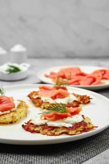 Closeup view of potato flapjacks with salmon and cream cheese