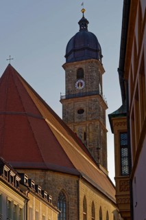 The setting sun colours the sky above an old town church Basilica of St. Martin, Rathausgasse,