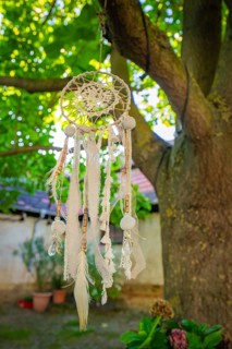 Close-up of a dreamcatcher hanging from a tree in an illuminated garden, Harz Mountains, Germany,