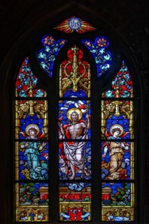 A colourful stained glass window with Christian motifs in the Basilica of St. Martin, Amberg, Upper