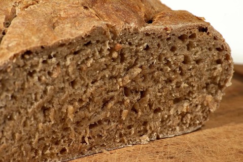 Bread loaf, grey bread, cut, on wooden board