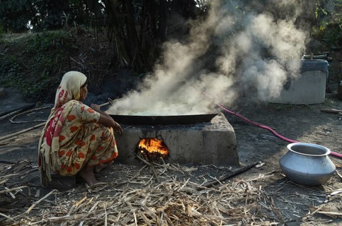 Workers boiling sugarcane juice as they are making Gur (jaggery) in a village on December 10, 2021