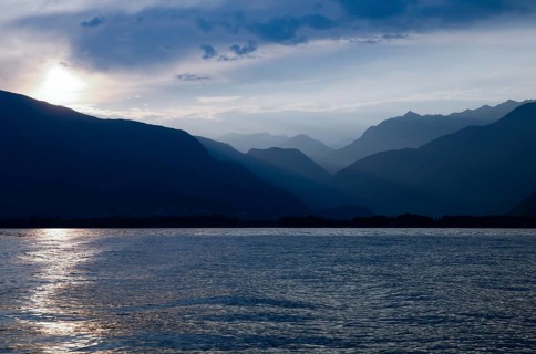 Beautiful Sunset over an Alpine Lake Maggiore with Mountain Range and Sky in Ticino, Switzerland,