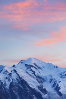 Red-coloured clouds over the summit of Mont Blanc with Aiguille du Midi in the foreground, Savoie,