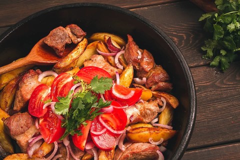 Ojakhuri, Traditional Georgian dish, fried potatoes with meat, in a clay frying pan, top view, no