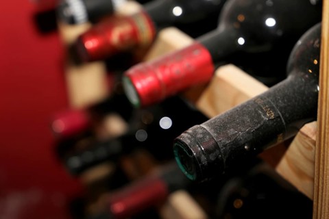 Wine cellar with red wine bottles
