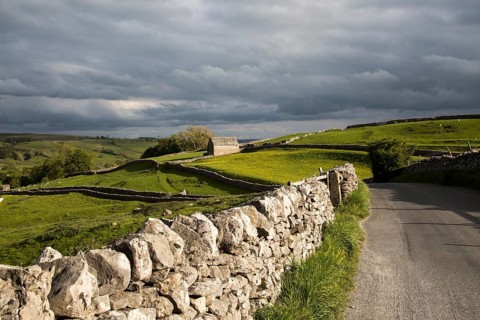 Old barn and dry stonewalls, Malham, Yorkshire Dales national park, England, UK