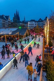 Ice rink at the Christmas market on the Heumarkt in the old town of Cologne, Cologne Cathedral,