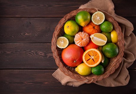 Assortment, citrus fruits, in a basket, close-up, top view, no people